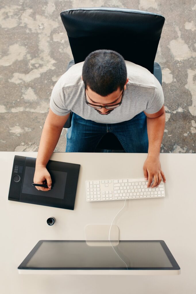 Designer using a graphics tablet and desktop