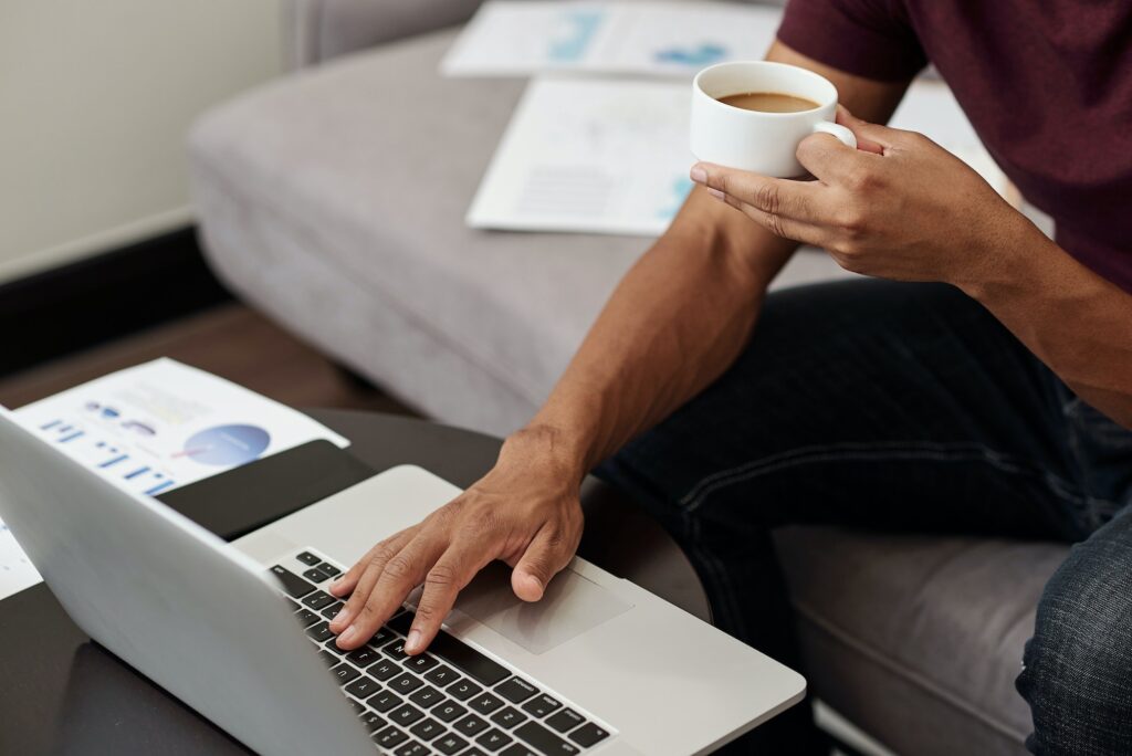 Hands typing on a laptop
