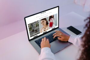 Hands editing a web page on a laptop for on-page SEO