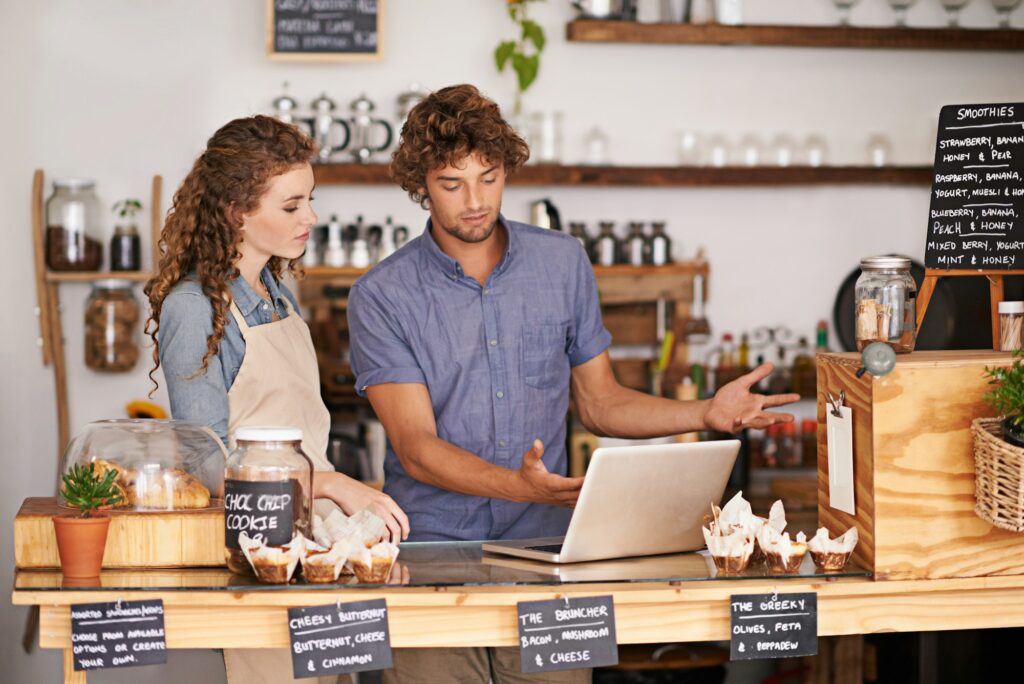 Shop owners working on a laptop