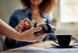 Customer paying in a cafe after finding it via Google Business Profile